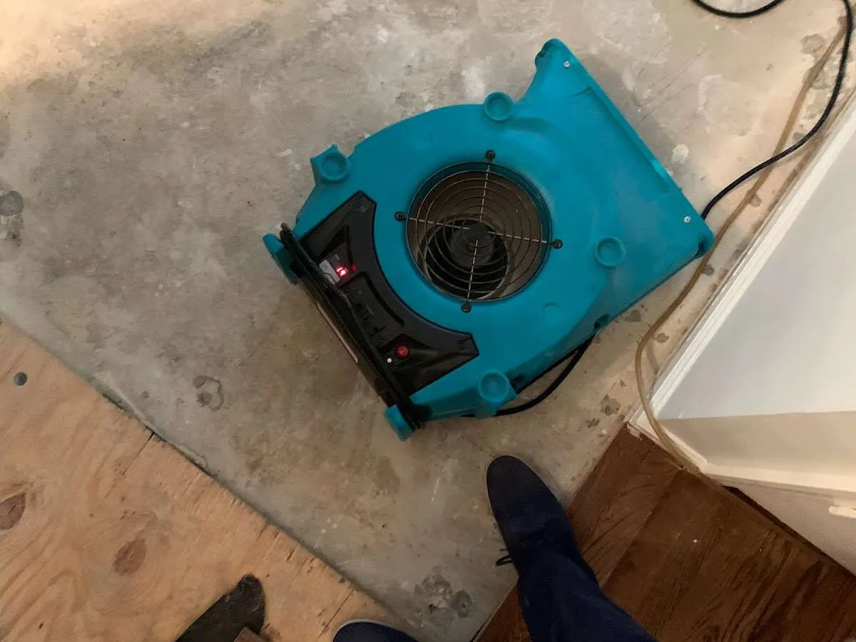 Air mover drying subfloor during Commercial Water Damage Restoration in Fort Worth